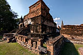 Thailand, Old Sukhothai - Wat Mahathat, square-based, multi-layered chedi with statues of seated Buddha at each side, stucco figures of lions and elephants decorate the base. 